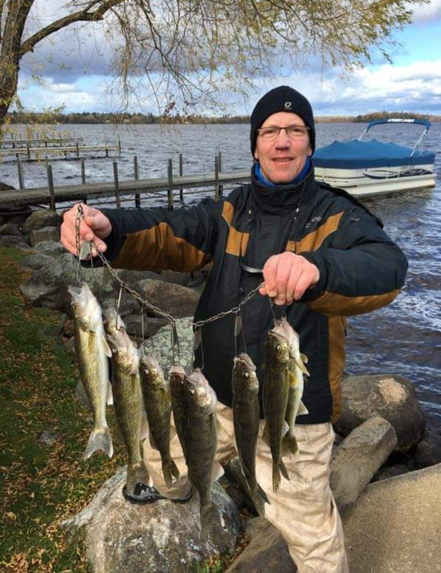 Gentleman showing the eight walleye that he caught with Lake Vermilion Guide Service